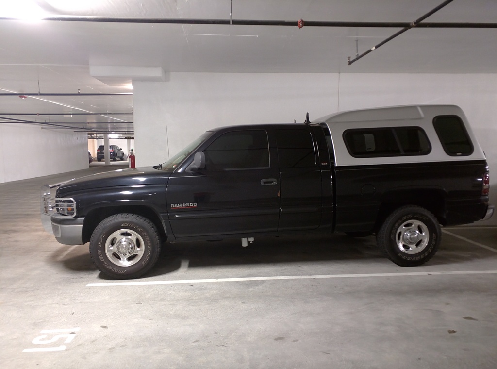 Dodge from the side with the silver camper shell